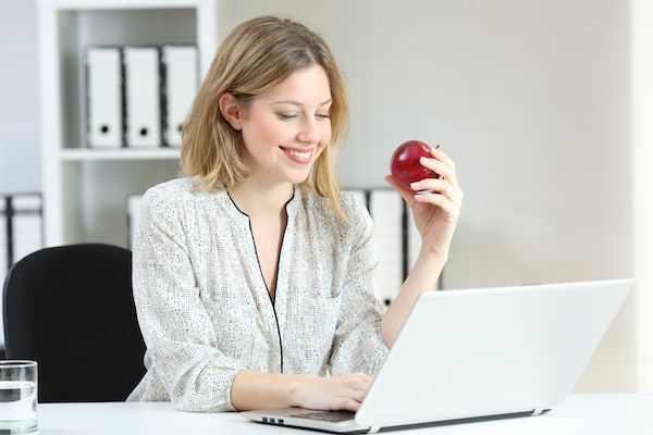 Business professional reading the latest from Unitek News on their laptop
